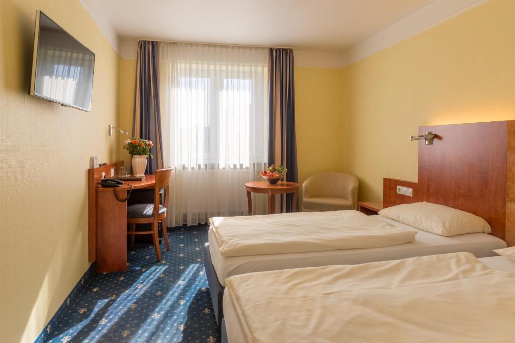 Postel nebo postele na pokoji v ubytování Aparthotel Astro - Nichtraucherhotel