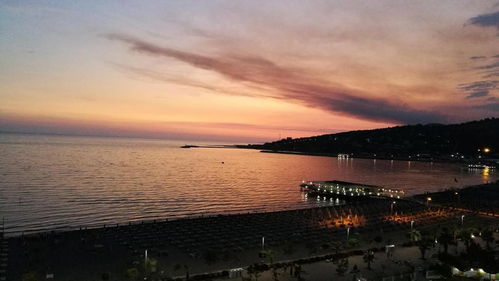 a view of a beach at sunset with the ocean at Nada SeaView Apartment in Shëngjin