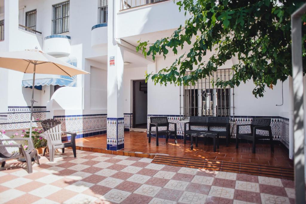 a courtyard of a building with a table and chairs at Casa Atlantis in Chipiona