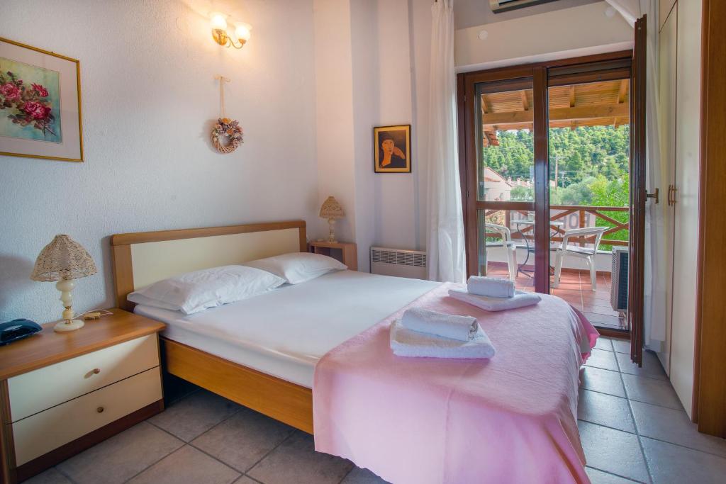 a small bedroom with a bed and a window at Casa Costa for 7 guests near Fourka beach in Skala Fourkas