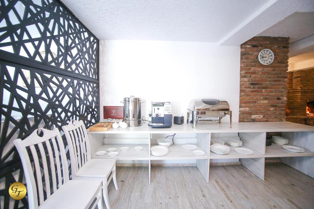 a kitchen with a table and chairs in a room at Hotel Green Town in Kutaisi