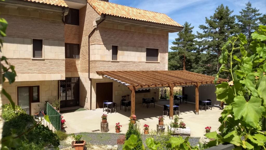 an outside view of a building with a pergola at El Nido de Pinares in Navaleno