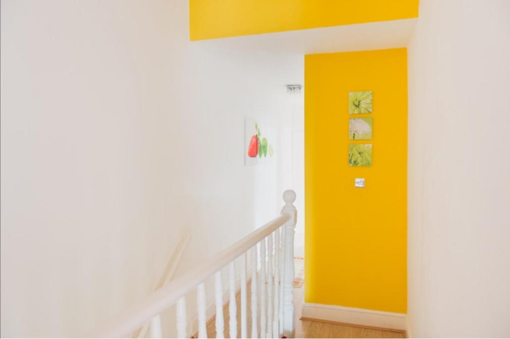 a yellow door in a room with a staircase at 03 Bedroom Apartment-Self Check in in London