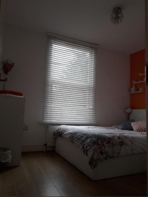 a bedroom with a bed and a large window at 03 Bedroom Apartment-Self Check in in London