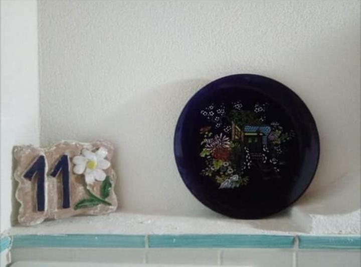 a black plate on a shelf with a number at VulKanoHome(EolieIslands) in Vulcano