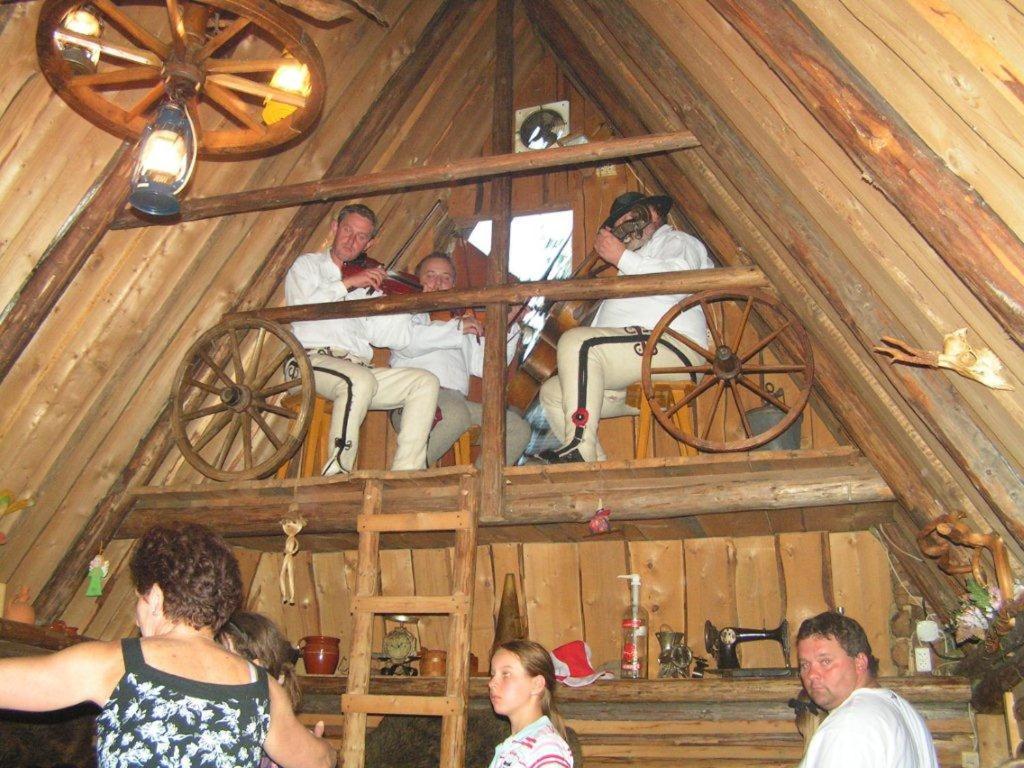 a group of people sitting in the inside of a cabin at Dom Wczasowy Dwa Światy in Bukowina Tatrzańska