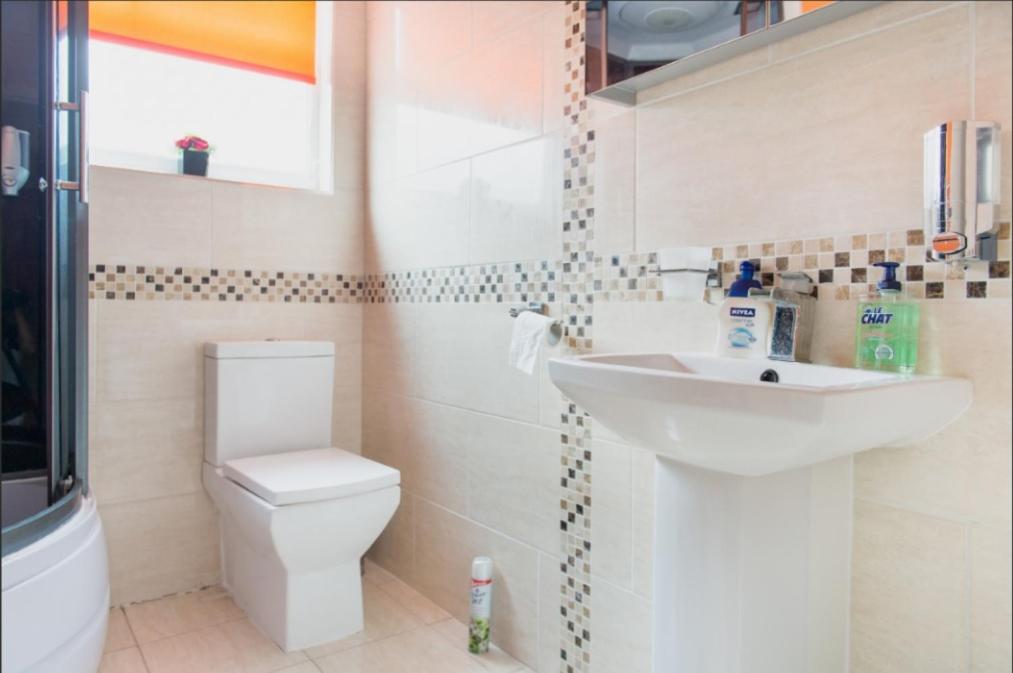 a bathroom with a toilet and a sink at 03 Bedroom Apartment-Self Check in in London