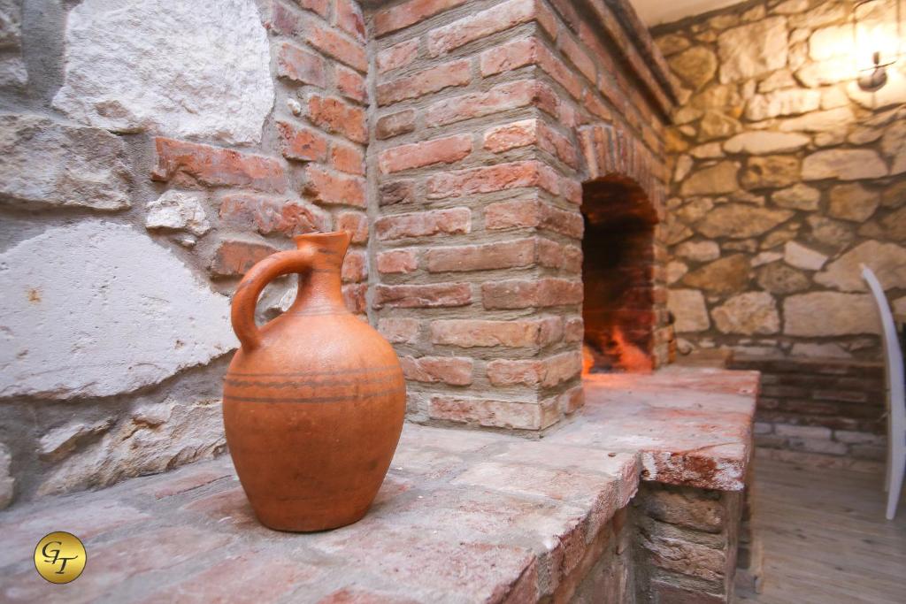 a brown vase sitting on a brick wall at Hotel Green Town in Kutaisi