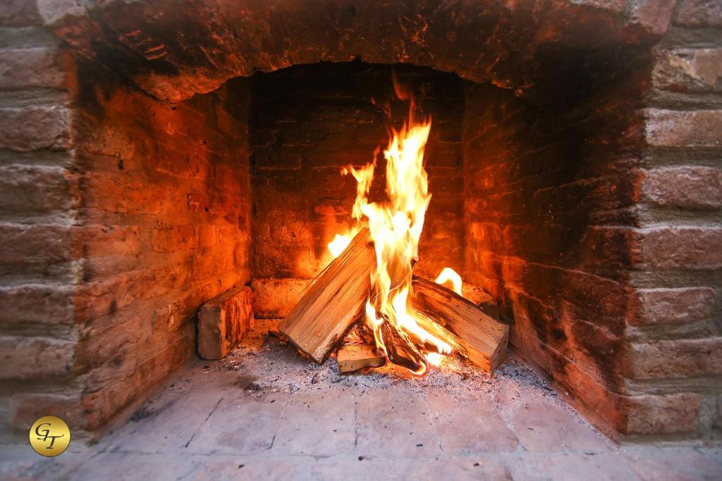 a brick oven with a fire in it at Hotel Green Town in Kutaisi