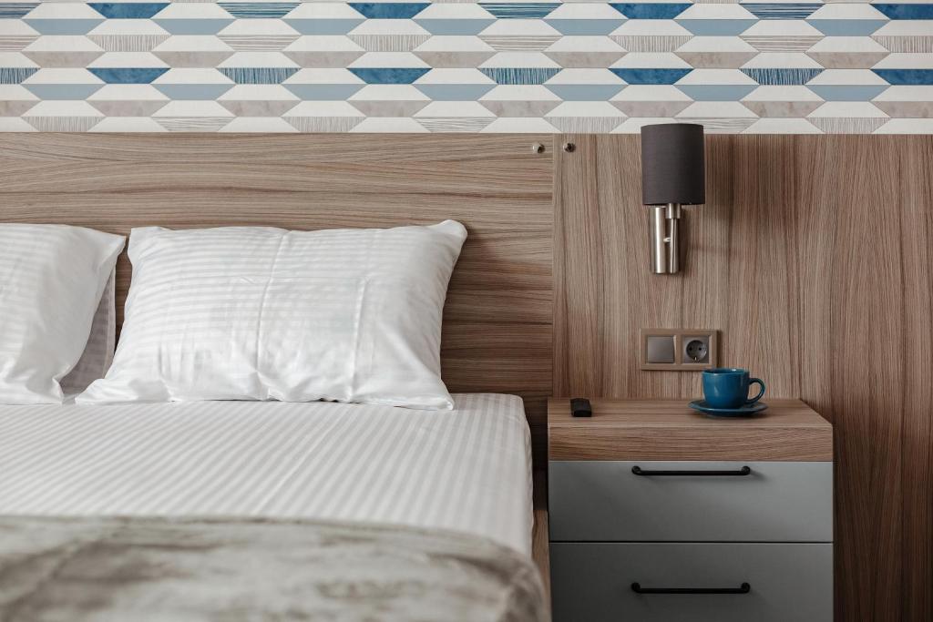 Postel nebo postele na pokoji v ubytování YUDGI - Home Hotel