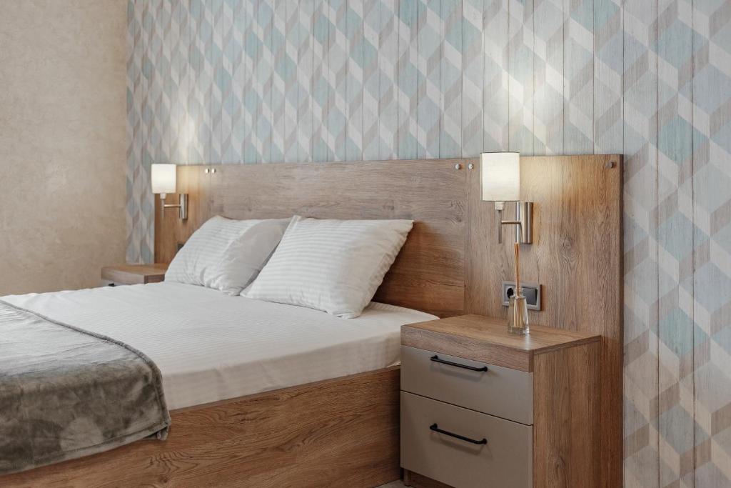 Postel nebo postele na pokoji v ubytování YUDGI - Home Hotel