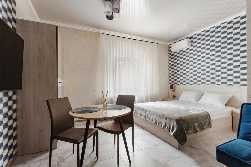 Postel nebo postele na pokoji v ubytování YUDGI - Home Hotel