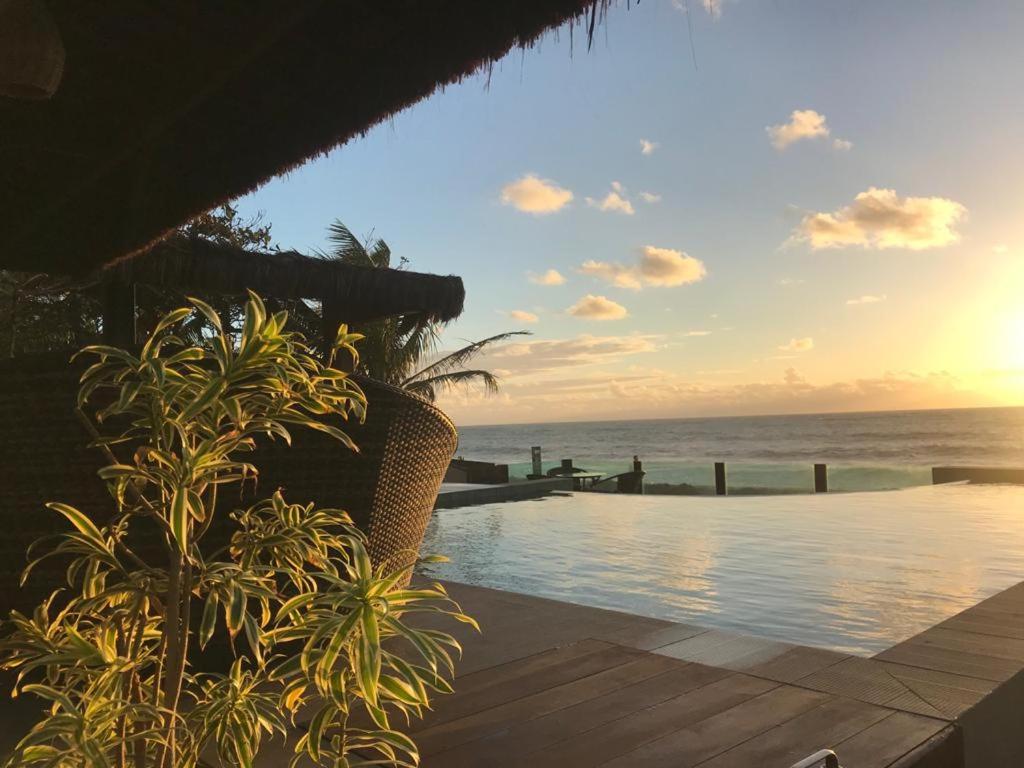 a swimming pool with a view of the ocean at Pousada Maracabana Spa in Porto De Galinhas