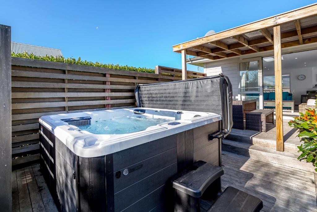 a hot tub on the deck of a house at Casa Toscana in Martinborough