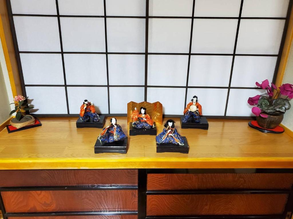 a group of figurines sitting on top of a wooden table at サムライストリートハウス武家屋敷通り in Daisen