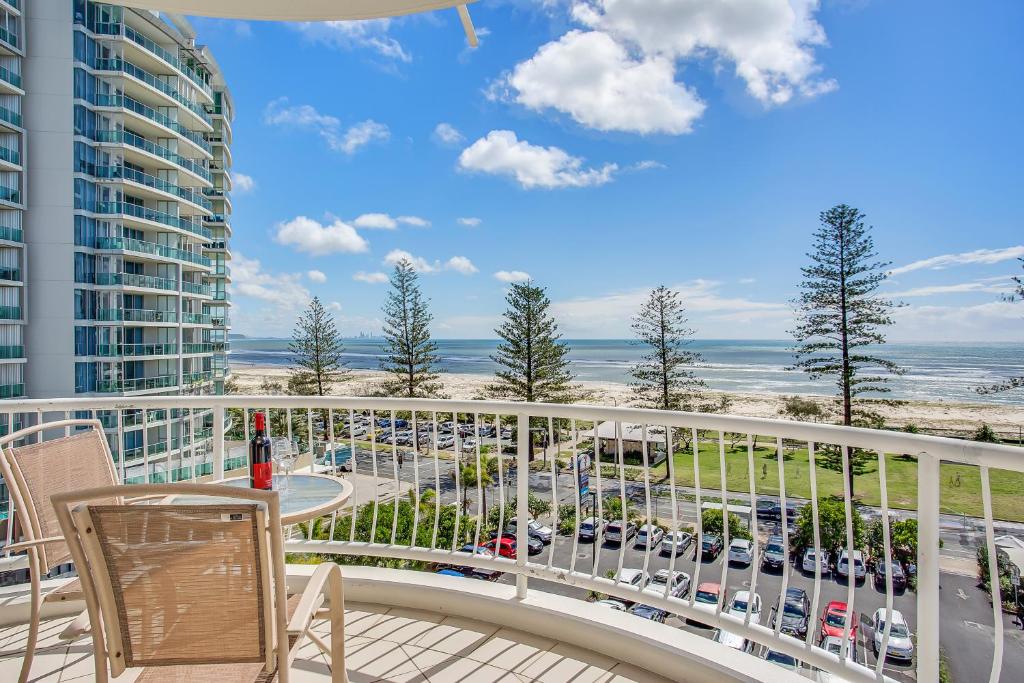 a beach with a balcony overlooking the ocean at Kirra Beach Apartments in Gold Coast