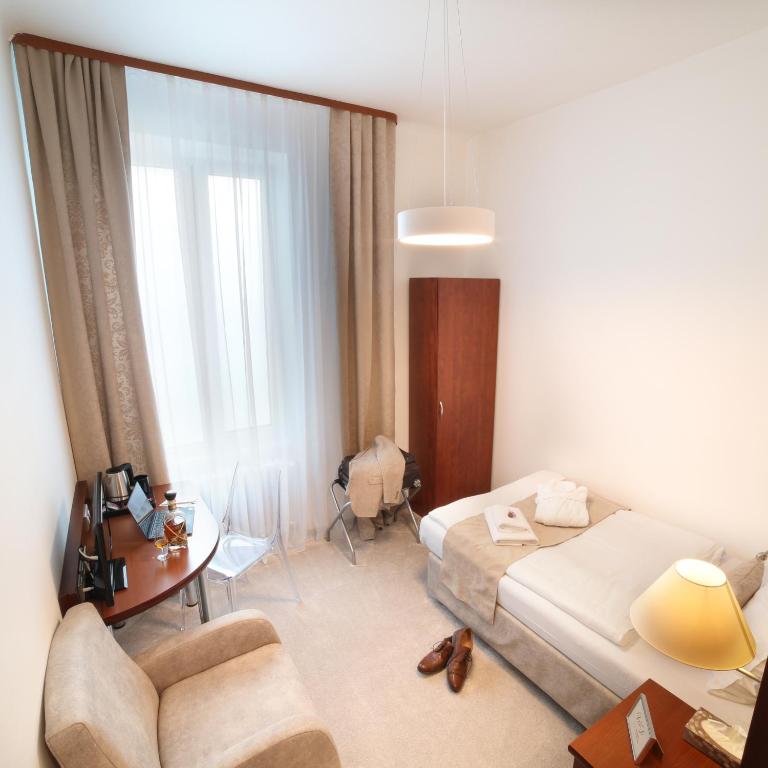Postel nebo postele na pokoji v ubytování Hotel KOZÁK