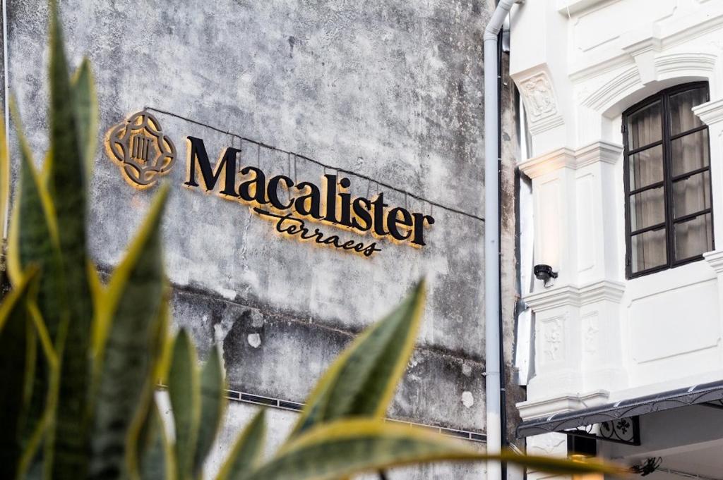 a sign on the side of a building at Macalister Terraces Hotel in George Town