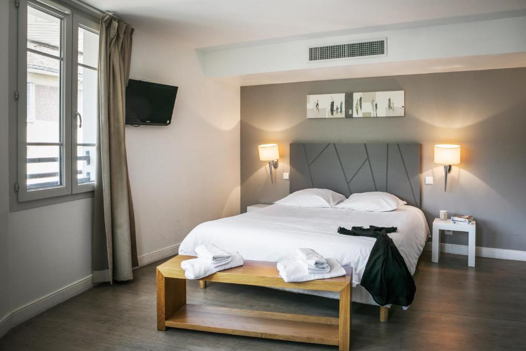 Ένα ή περισσότερα κρεβάτια σε δωμάτιο στο Zenitude Hôtel-Résidences Lorda