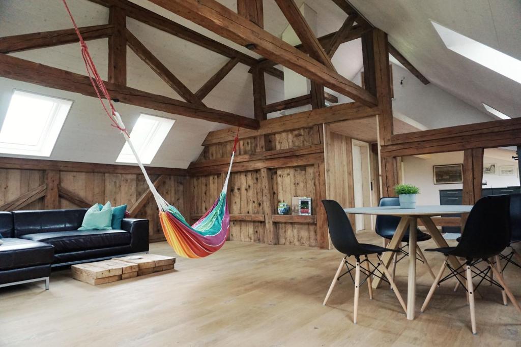a living room with a hammock hanging from the ceiling at NEU renoviert - Bitzi Appenzell – Mit Aussicht in Appenzell