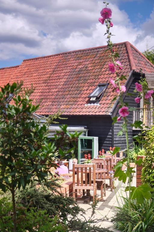 a house with a table and chairs in front of it at The Westleton Crown in Westleton