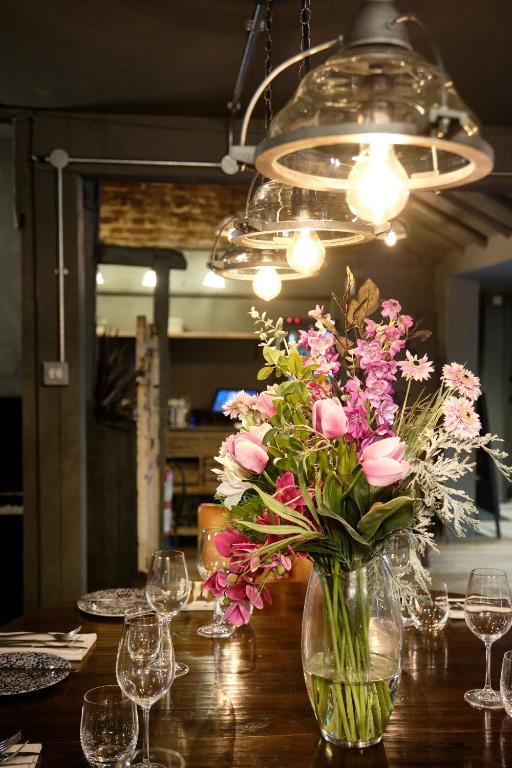 a vase filled with pink flowers sitting on a table at The Westleton Crown in Westleton