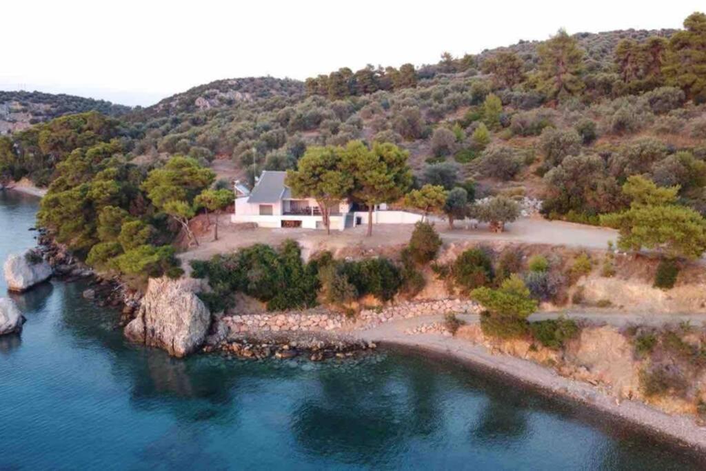 an aerial view of a house on an island in the water at SECRET PARADICE-HIDDEN GETAWAY-PRIVATE BEACH in Taktikoúpolis