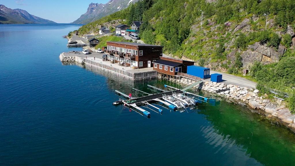 an aerial view of a dock with boats in the water at Ersfjordbotn Brygge in Ersfjordbotn