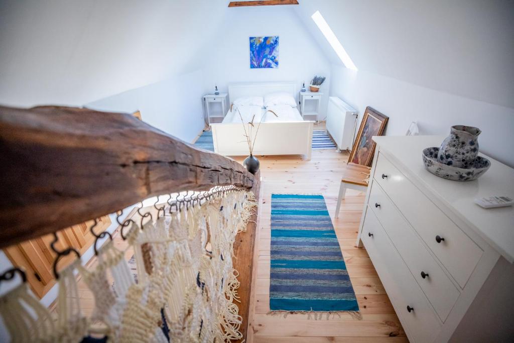 a attic room with a bed and a rug at Casa Paulini in Cisnadioara