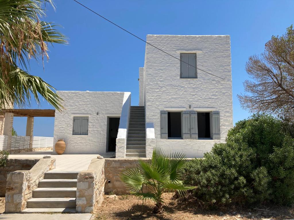 a white house with stairs in front of it at LA MAISON D'HELENE in Naousa