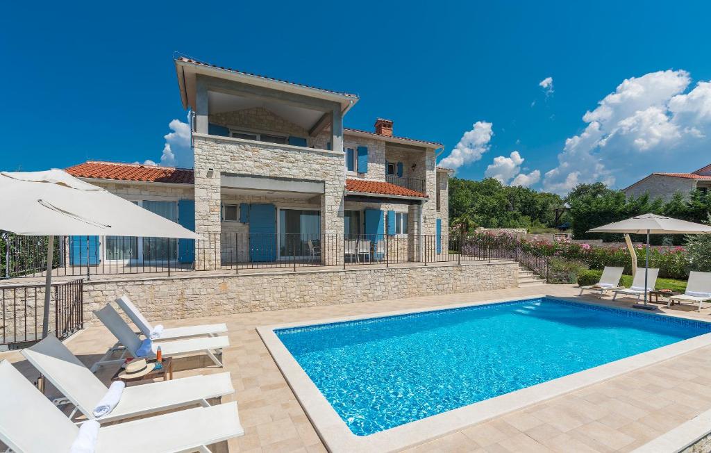 a villa with a swimming pool and a house at Villa Sterpazzi - near Porec with Sea View, private Jacuzzi, Sauna and Pool in Višnjan