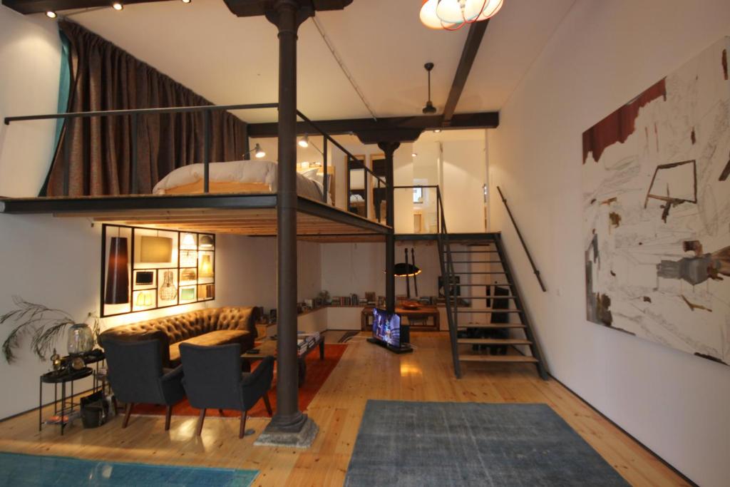 a living room with a loft bed and a couch at I Loft Lisbon - Bairro Alto in Lisbon
