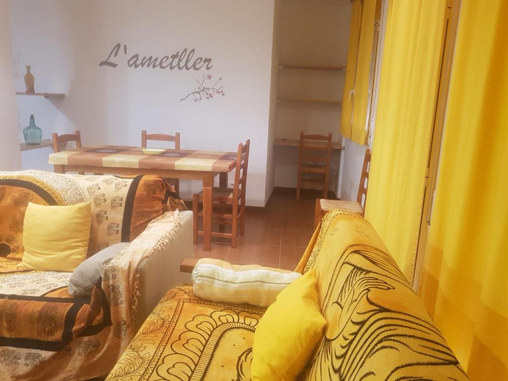 a living room with two couches and a table at Can Panxeta in Pallaresos