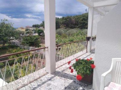 a balcony with a view of the ocean on a hill at Apartments Medici in Zaostrog