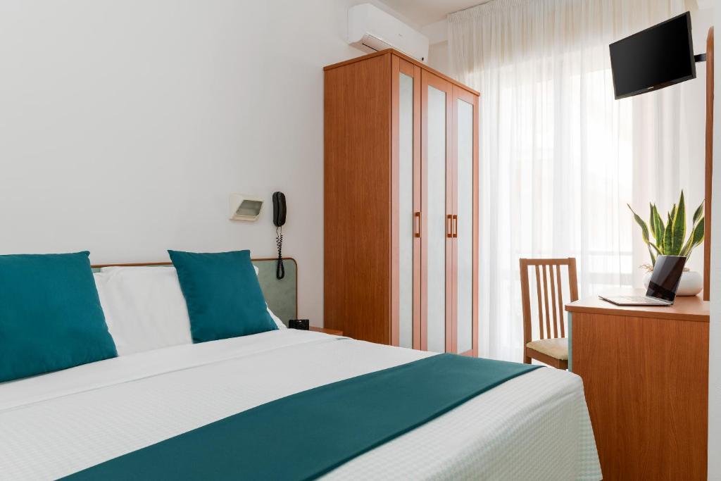 Postel nebo postele na pokoji v ubytování Hotel Très Jolie