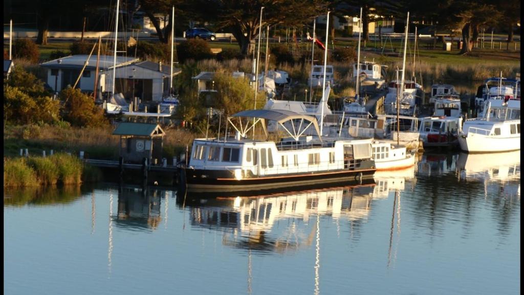 a group of boats docked in a marina at Swamp Fox luxury 2BR Dutch Barge in Goolwa