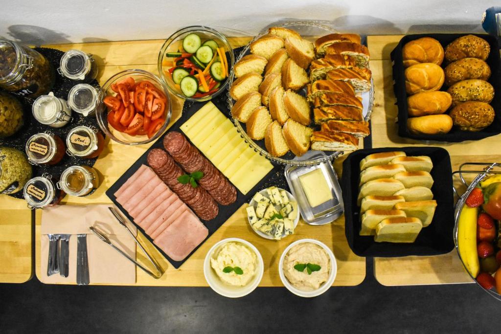 a table topped with lots of different types of food at Hotel Vincent in Luhačovice