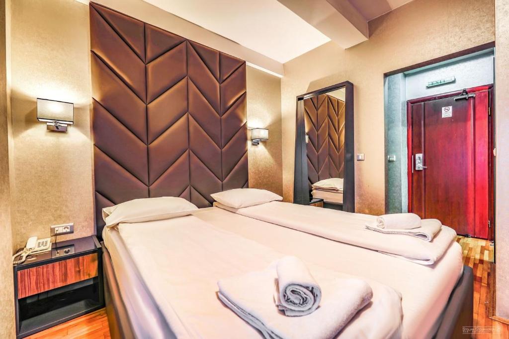 Postel nebo postele na pokoji v ubytování Tino Hotel & SPA