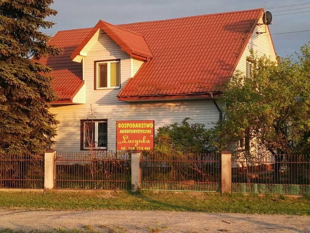 a house with a sign in front of it at Gospodarstwo Agroturystyczne Lucynka in Urszulin