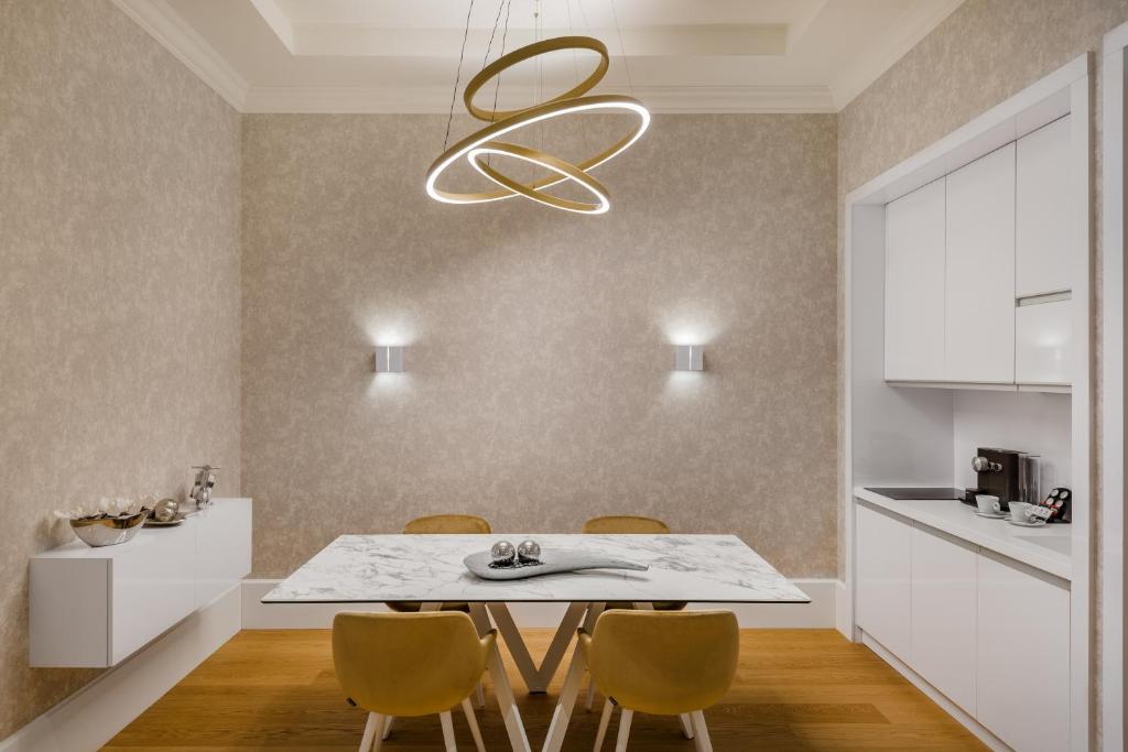 a kitchen and dining room with a table and chairs at Hotel Vision Budapest by Continental Group in Budapest