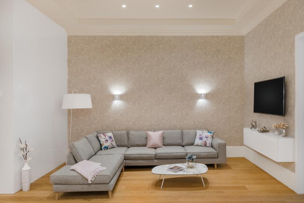 a living room with a couch and a tv at Hotel Vision Budapest by Continental Group in Budapest