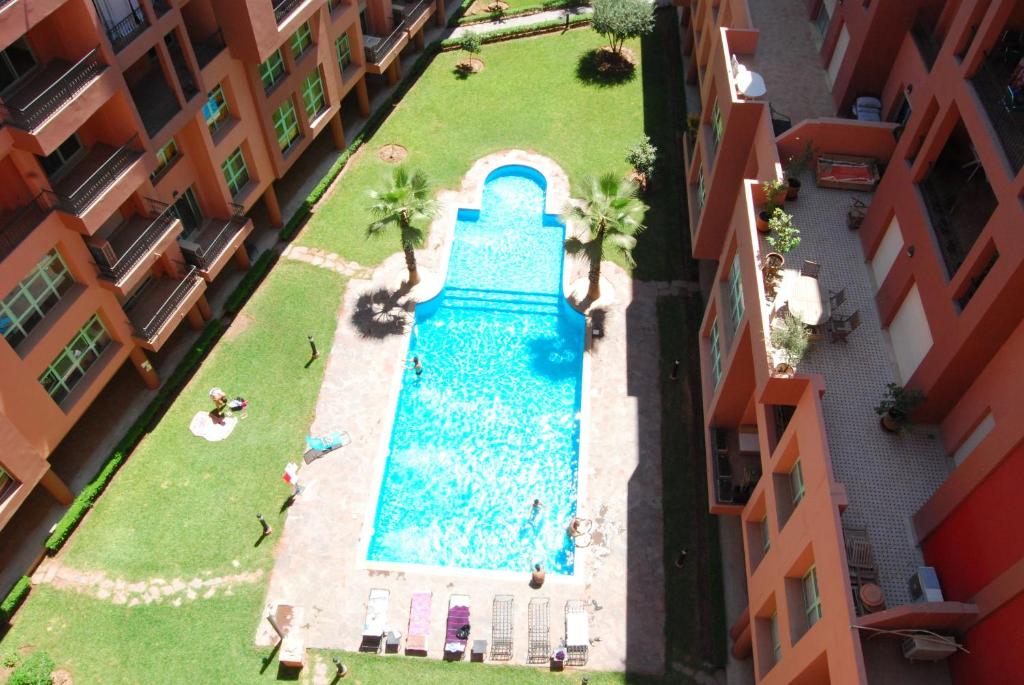 an overhead view of a swimming pool between two buildings at Appartement Mirador De Majorelle in Marrakesh