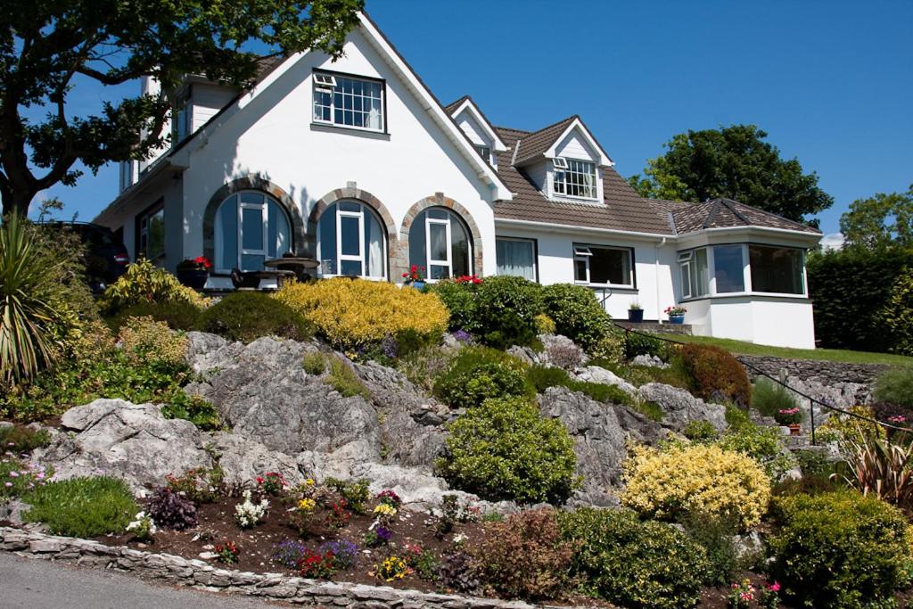 a house with a rock garden in front of it at Rockcrest House in Kenmare