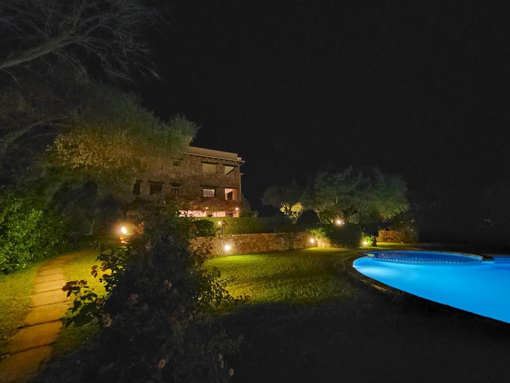 a swimming pool at night with a house in the background at Sole&Luna Apartments in Porto Rotondo