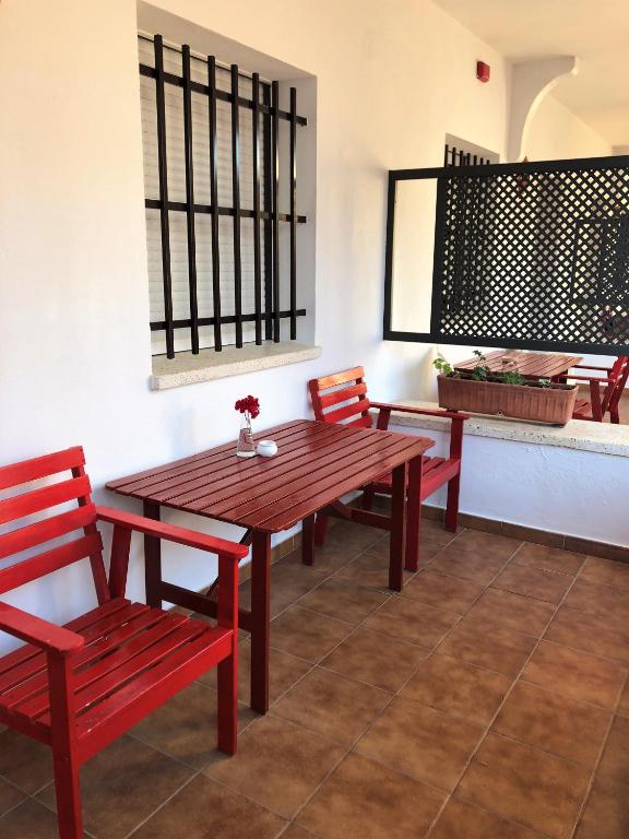 a wooden table and chairs in a room at Hostal Alhambra in Zahora