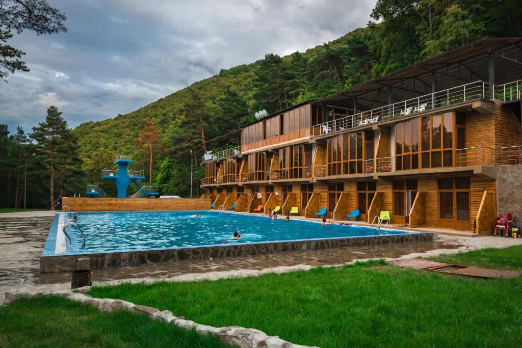 a large swimming pool in front of a building at Chayka Hotel Ingushetia in Armkhi