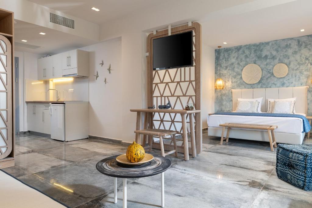 a bedroom with a bed and a table in a room at Notia Luxury Living in Porto Koufo