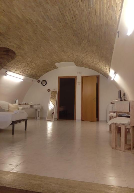 a large living room with a couch and a table at Residenza l'Orologio in Bernalda
