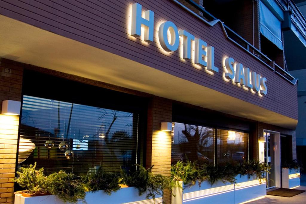 a store front of a hotel with a sign on it at Hotel Salus in Pescara