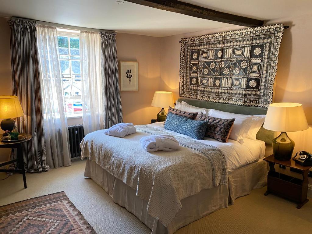 a bedroom with a large bed with two towels on it at Royal Oak Ramsden in Ramsden